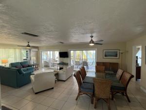 a living room with a couch and a table and chairs at Tropical Sunsets in Marathon