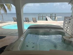a jacuzzi tub with a view of the ocean at Tropical Sunsets in Marathon