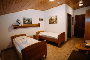 a room with two beds and a table at Bouda Malenovice in Malenovice