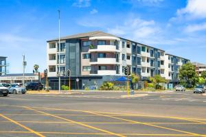 an empty parking lot in front of a building at Cape on Popham 21B in Bloubergstrand