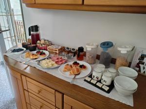 a table with plates of food on a counter at Romantiche Orobie B&B in Bordogna +34 photos