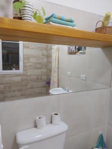 a white bathroom with a toilet and a sink at Felicità in Realicó