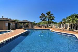 a large swimming pool with chairs and a fence at Pacific Shores B102 · PacSB102 Family Getaway 3BD Across Beach in Kihei
