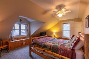 a bedroom with a bed and a ceiling fan at A Mountain Hideaway in Blowing Rock