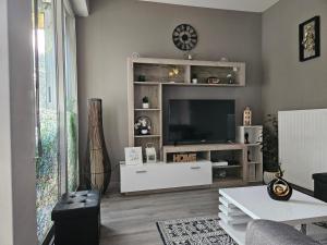 Idéal long séjour, Souvenirs de Provence,T2 classé, vue sur les montagnes, toutes commodités! في ديني-ليه-بان: غرفة معيشة فيها تلفزيون على مركز ترفيه ابيض