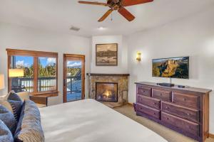 a bedroom with a bed and a fireplace at Upscale 3 BR Townhouse @ Juniper Preserve Resort in Bend