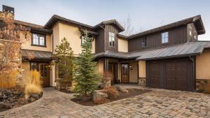 a large house with a garage and a driveway at Upscale 3 BR Townhouse @ Juniper Preserve Resort in Bend