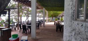an outdoor patio with tables and chairs and a building at Ecohotel Nativa Beach in Cartagena de Indias +46 photos