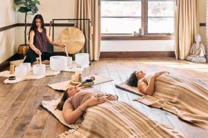 two women laying on the floor in a room at Upscale 3 BR Townhouse @ Juniper Preserve Resort in Bend +18 photos