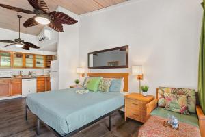 a bedroom with a bed and a couch and a kitchen at Napili Shores D227 · NS D227 OceanFront Resort w Pool in Kahana +54 photos