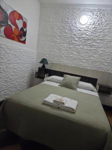 a bedroom with a bed with a towel on it at HOTEL HM in Córdoba +18 photos