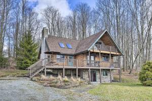 a large wooden house with a large deck at Wander & Unwind Log Cabin And Suites At Equestrian House in Pleasant Mount