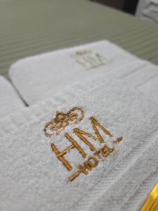 a white towel with the word new hotel on it at HOTEL HM in Córdoba