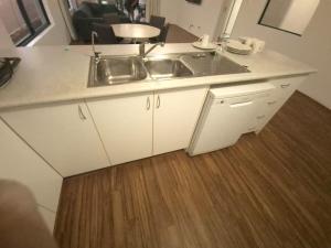 a kitchen with a sink and a wooden floor at Dalyellup 2BR accommodation-Rear Guest house Unit- Walkable to major supermarkets in North Boyanup +22 photos