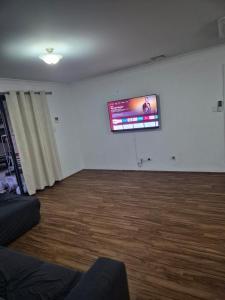 a living room with a flat screen tv on a wall at Dalyellup 2BR accommodation-Rear Guest house Unit- Walkable to major supermarkets in North Boyanup