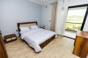 Giường trong phòng chung tại LACASA Kiyovu - Serviced Apartments