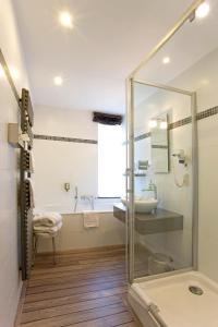 a bathroom with a glass shower and a sink at Moulin de Daverdisse in Daverdisse