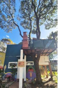a tree house with a deck on top of it at Minicasa Brasileira in Sorocaba