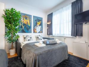 a bedroom with a bed and a large window at Superior Studio at St Stephen's Cathedral City Center - 1 min walk to Vienna City Center in Vienna
