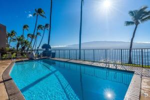 a swimming pool with a view of the ocean at Lauloa 105 · LOA 105 2BD OceanFront Getaway w AC Pool in Wailuku