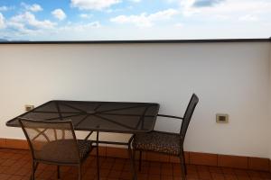a table and two chairs on a balcony at Agriturismo Il Falco in Velletri