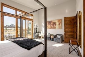 a bedroom with a bed and a large window at Arden House in Redmond