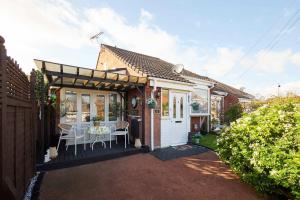 a house with a table and chairs in a yard at Host & Stay - The Cheeky Squirrel in New Brighton