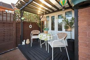 a patio with a table and chairs on a deck at Host & Stay - The Cheeky Squirrel in New Brighton