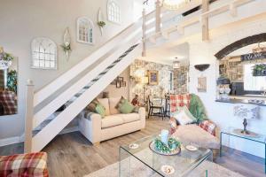 a living room with a couch and a staircase at Host & Stay - The Cheeky Squirrel in New Brighton +22 photos