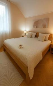 a bedroom with a large bed with a bowl on it at ZARA apartment- Near the Old town , 3 ACs , Free Parking, Peaceful in Mostar
