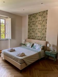 a bedroom with a bed with two pillows on it at Il Teatro in Acquapendente