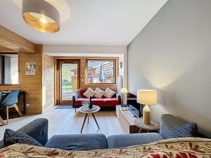 a living room with a couch and a table at La Bruyere - appartement - 6pers in Les Gets