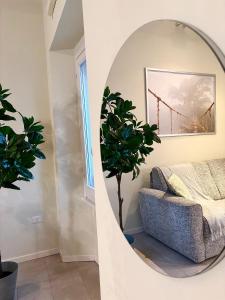 a living room with a mirror and a couch at Nido di Rossini in Pesaro