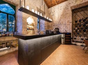 a bar in a room with a bunch of wine bottles at Historic Han Hideaway in Vrana