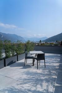 a table and two chairs sitting on top of a roof at Lake & More Suite Hotel in Paratico