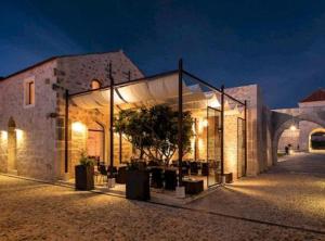 a building with a tree inside of it at night at Historic Han Hideaway in Vrana