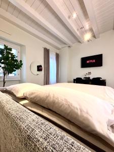 a bedroom with a large bed with a tv on the wall at Nido di Rossini in Pesaro