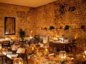 a restaurant with tables and chairs and a stone wall at Historic Han Hideaway in Vrana +22 photos