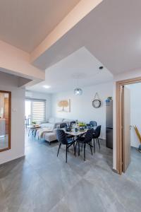 a living room with a table and chairs and a couch at TelMar Sky View in Larnaca