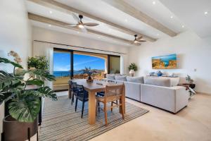 a living room with a table and a couch at Oceanfront Infinity Pool Vera Neo Beach Club Gym in San José del Cabo