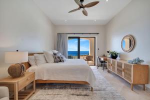 a bedroom with a bed and a view of the ocean at Oceanfront Infinity Pool Vera Neo Beach Club Gym in San José del Cabo +46 photos