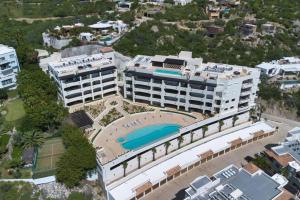 an aerial view of a building with a swimming pool at Oceanfront Infinity Pool Vera Neo Beach Club Gym in San José del Cabo