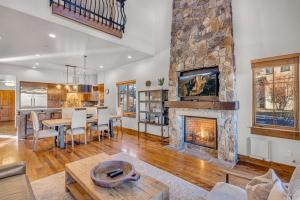 a living room with a fireplace and a dining room at Upscale 4 BR Townhouse @ Juniper Preserve Resort in Bend