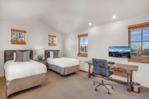 two beds and a desk in a room with windows at Upscale 4 BR Townhouse @ Juniper Preserve Resort in Bend +24 photos
