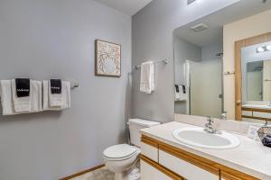 a bathroom with a toilet and a sink and a mirror at Alpine Paradise in Leavenworth +10 photos