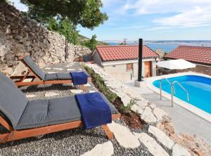 a backyard with a swimming pool and a stone wall at Ana Stone House Jurcic Kalic in Vranjak