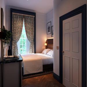 Ένα ή περισσότερα κρεβάτια σε δωμάτιο στο Bertrand's Townhouse