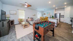 a living room with a foos ball on a table at Golf and Beach Getaway in Sunset Beach