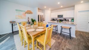 a kitchen and dining room with a wooden table and chairs at Golf and Beach Getaway in Sunset Beach
