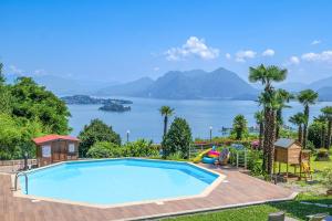 a swimming pool with a view of the water at Villa Anna Isole Borromee in Baveno +15 photos
